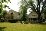The upper deck that leads to a large rear yard and beautiful gardens.